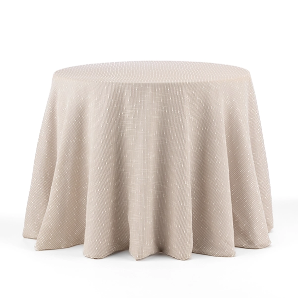 A round table with a beige tablecloth featuring a subtle, linear pattern is perfect for any event. Consider using the Riga Sand overlay rental to add an elegant touch.