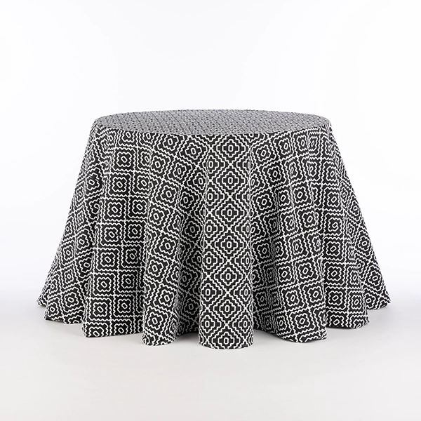 Round table featuring the Campbell Black geometric tablecloth rental, set against a plain white background.