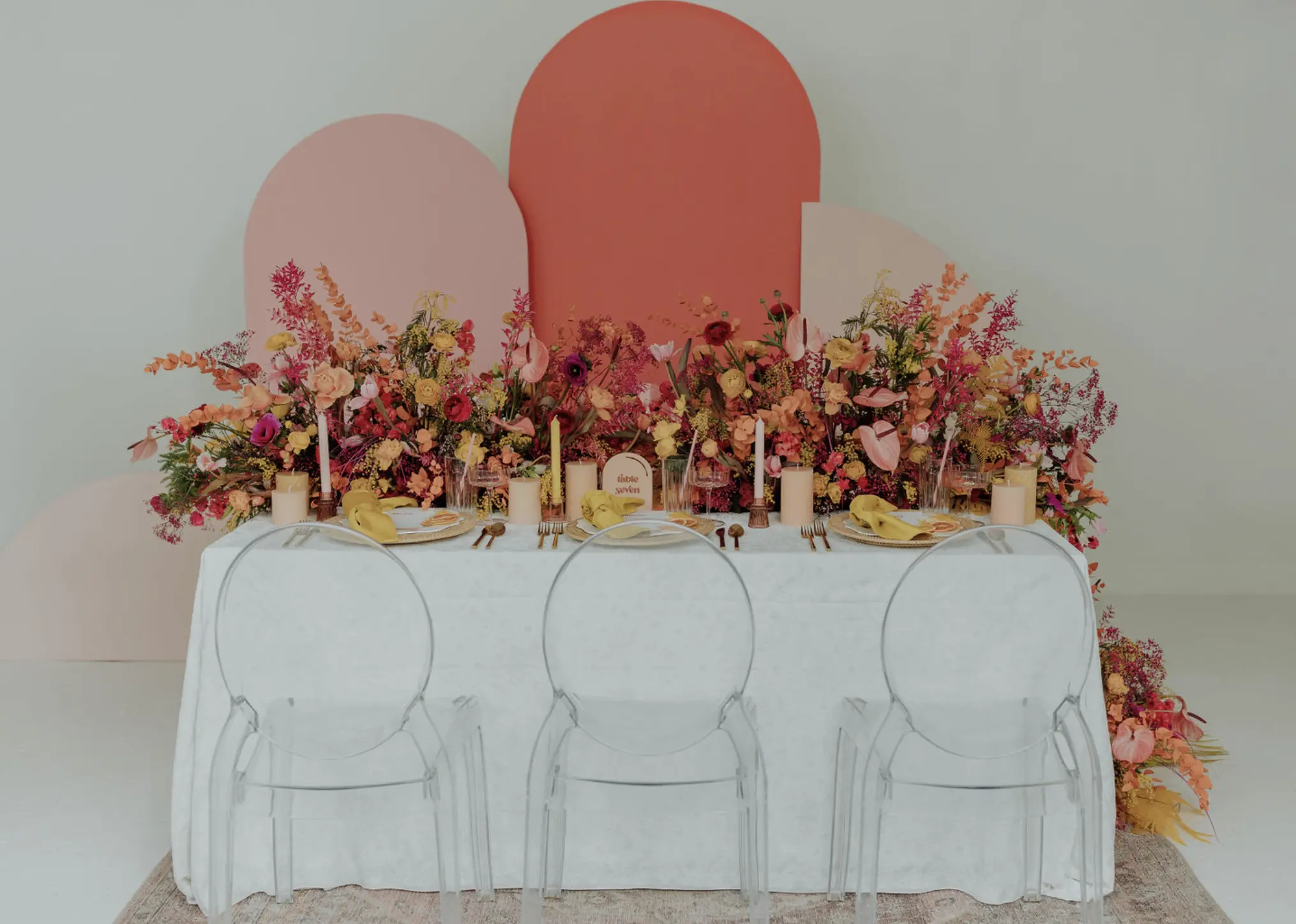 A View of a table with luxury linen rentals: Velvet Marigold Napkins, Gracie Pearl Tablecloth.