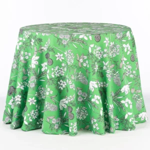 An event Dixie Fern Green linen rental with a green tablecloth featuring a floral pattern.