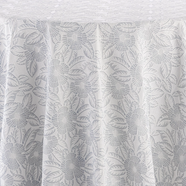 A Gracie French Grey tablecloth with a floral pattern available for table linen rental.