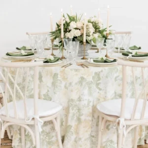 A beautifully arranged table set for a dinner party, featuring Velvet Evergreen Napkin event linen rental.