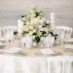A table setting with elegant white and silver decorations featuring Metropolitan Champagne, perfect for your event.