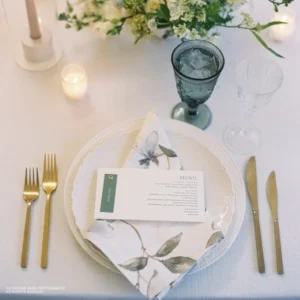 A table with Magnolia Fog Napkin rental and glasses.