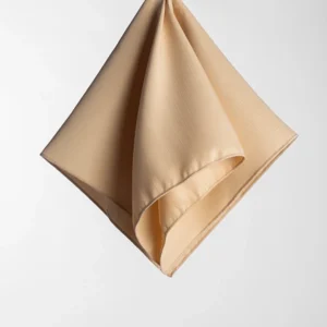 A Monaco Gold handkerchief with a textured pattern hangs against a white background.