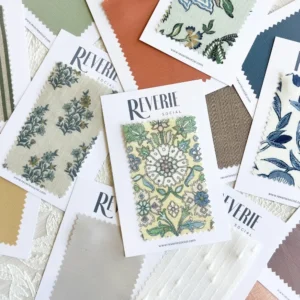 Scattered fabric swatches with floral and geometric designs, labeled "The Swatch Edit Vol. 1." Swatches include various colors and patterns on small cards.