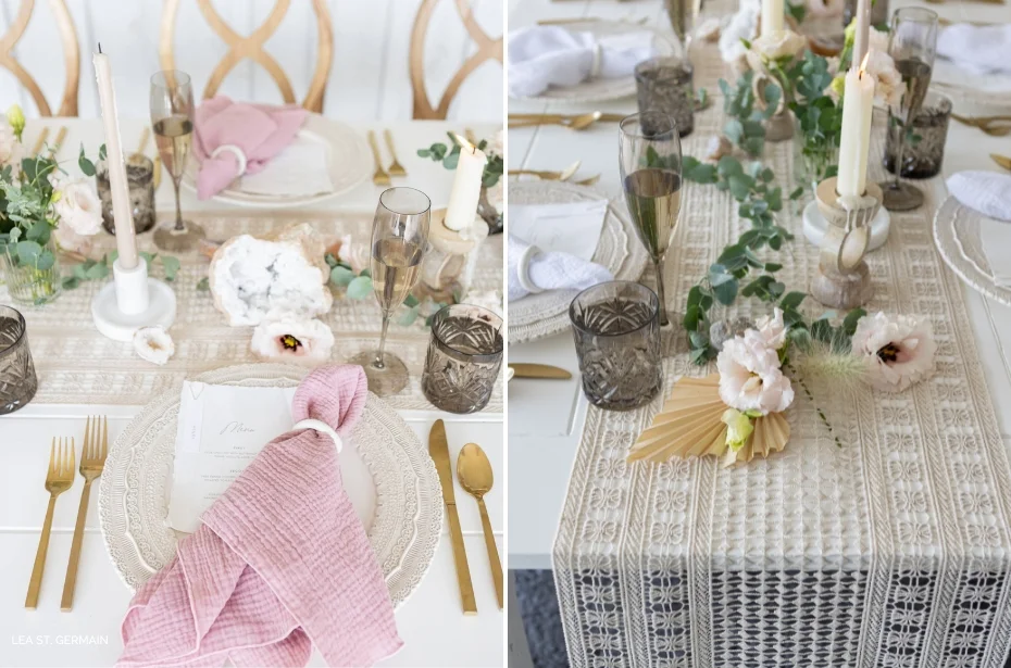 Elegant tabletop setup featuring gold cutlery, intricate white plates, mauve napkins, floral centerpieces, and candles on a lace table runner. Glassware and menus are also arranged neatly.