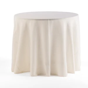 A round table covered with a simple, cream-colored tablecloth.