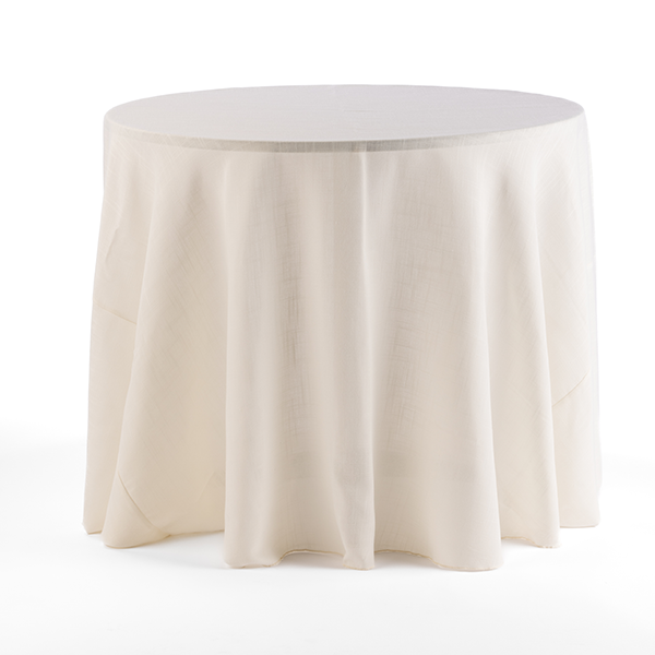 A round table covered with a simple, cream-colored tablecloth.