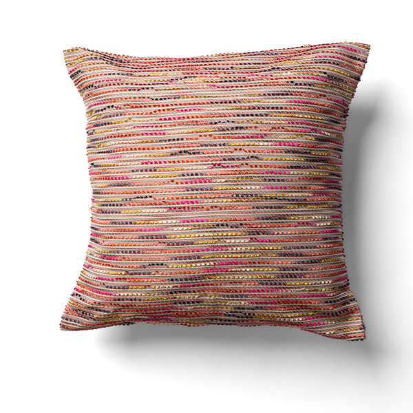 A square cushion with a multicolored striped pattern featuring shades of red, pink, and yellow on a white background.