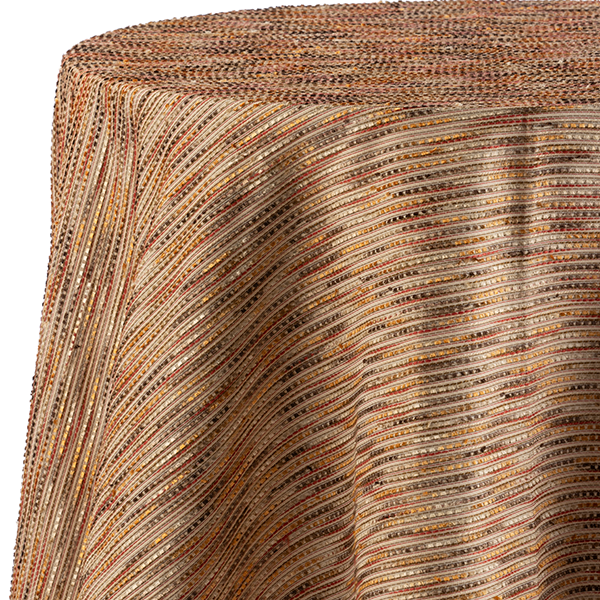 A round table draped with a fabric featuring a pattern of wavy, multicolored lines in shades of brown, orange, and yellow.