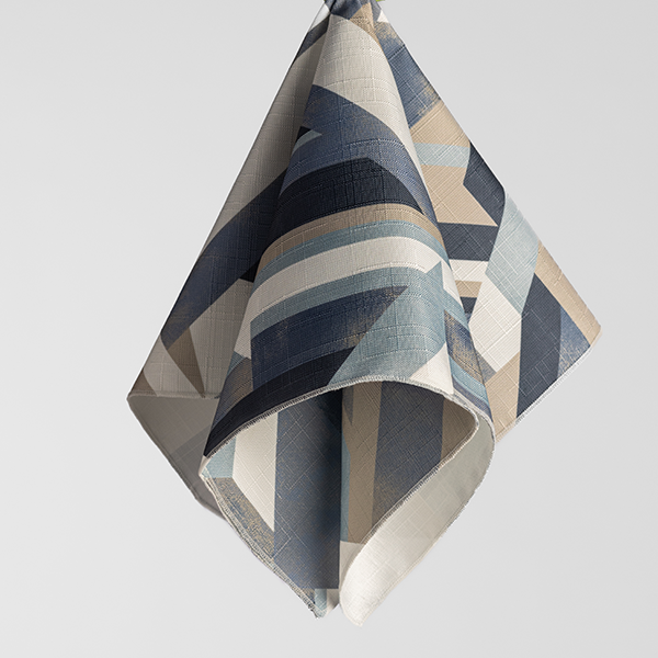 Hanging textile with an abstract geometric pattern in shades of blue, beige, and gray.