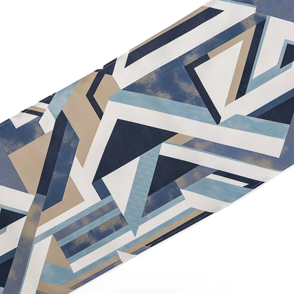 A fabric with a geometric design featuring angular shapes in shades of blue, beige, and white.