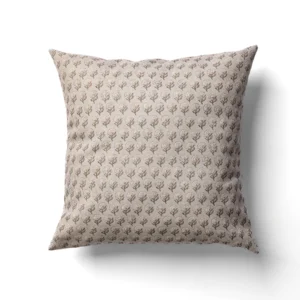 A square beige pillow featuring a repeating pattern of small, tree-like designs.