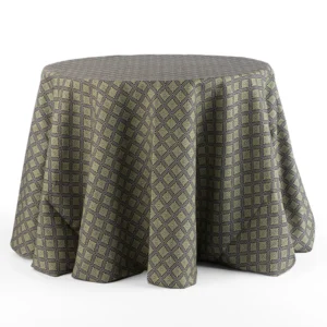 A round table is covered with a dark-colored, patterned tablecloth featuring a geometric diamond design.