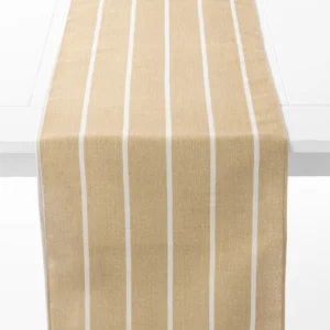 A beige table runner with white vertical stripes is draped over a white table.