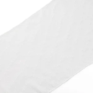 Close-up of a plain white fabric with a subtle, textured dot pattern. The fabric appears smooth and slightly sheer.