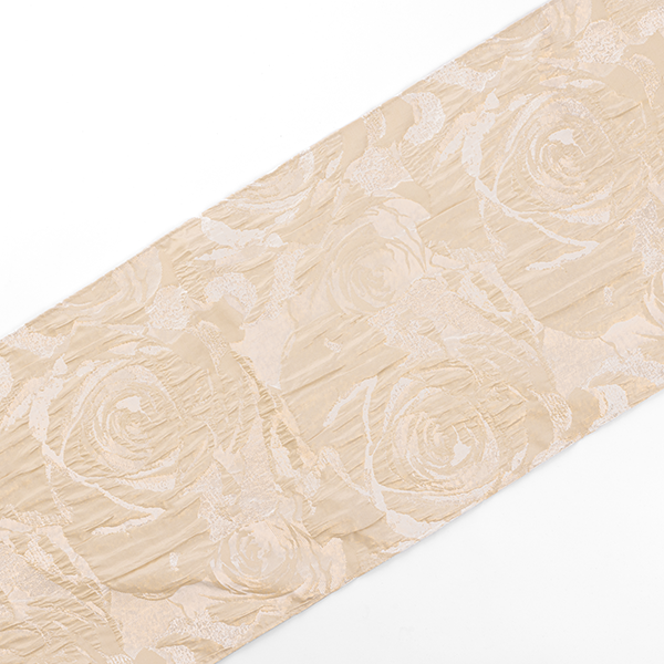 A beige fabric with an embossed floral pattern featuring roses, displayed on a white background.