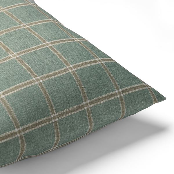 Green and beige plaid-patterned pillow photographed against a white background.