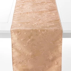 A beige, textured table runner is laid out on a white table.