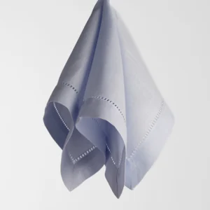 A neatly folded light blue handkerchief with decorative stitching floats against a plain white background.