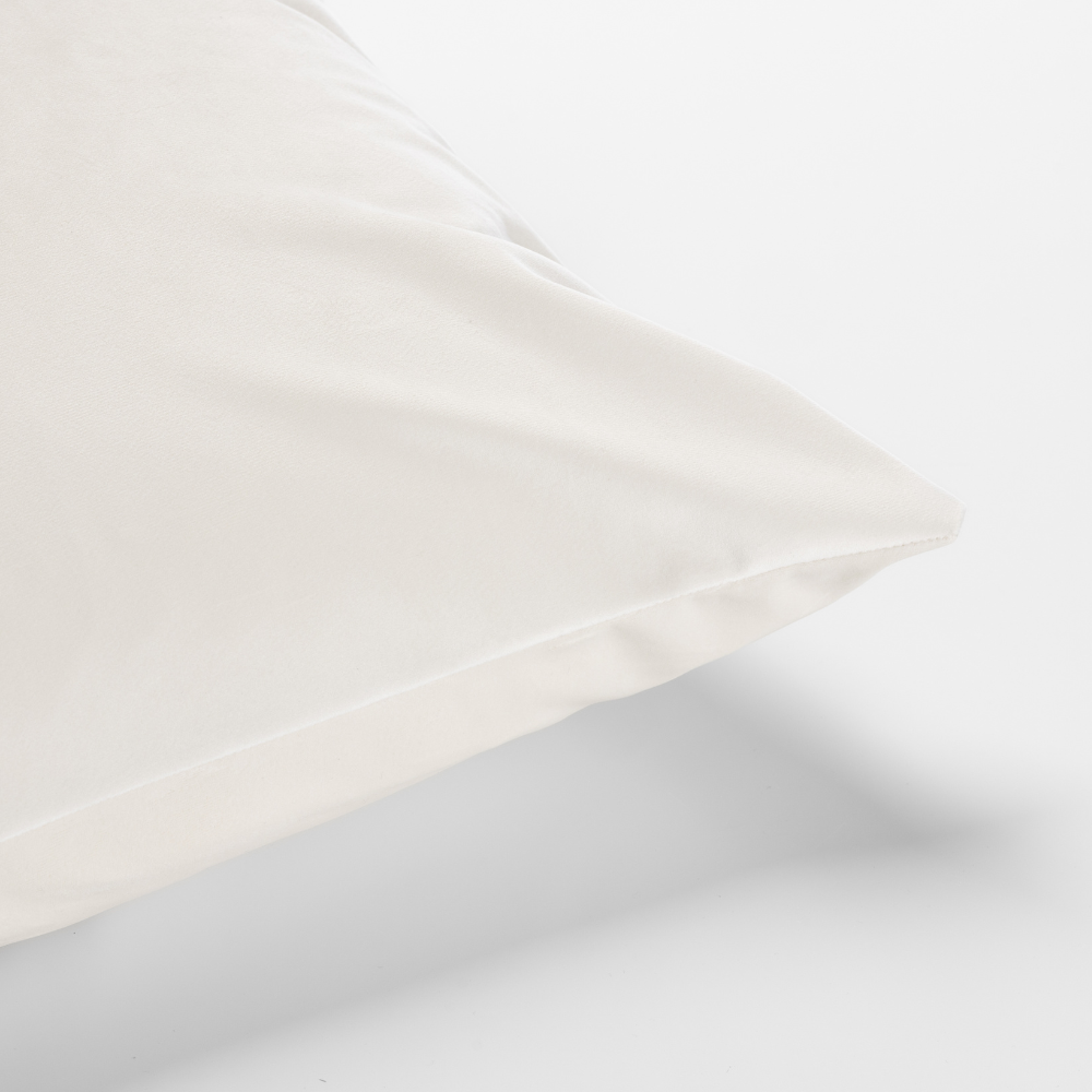 The Cafe Noir Velvet Pillow, characterized by its smooth white surface, is displayed against a plain white background.