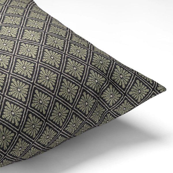 The Percival Olive Pillow features a geometric diamond pattern in green and black on a white background.