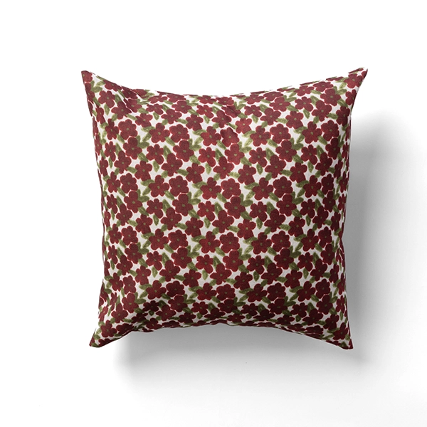 A Percival Olive Pillow featuring a square shape with a red floral pattern set against a white backdrop.