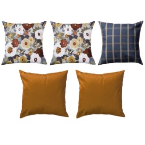 Five decorative pillows; three with floral patterns, one with a blue plaid design, and one solid orange.