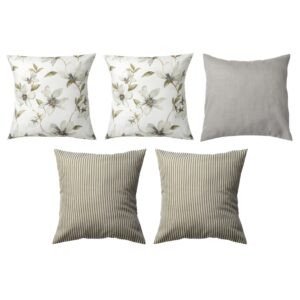 Six decorative pillows; three with floral patterns, one solid gray, and two with green and white stripes.