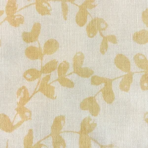 A fabric named Westerly Dusty Rose features a beige background adorned with light yellow, leafy vine patterns.