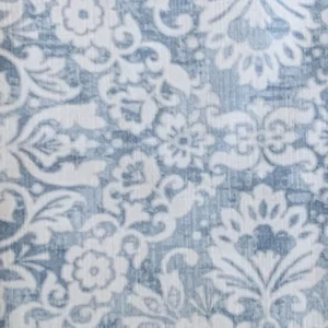 Westerly Dusty Rose features an intricate white floral pattern on a textured light blue background.