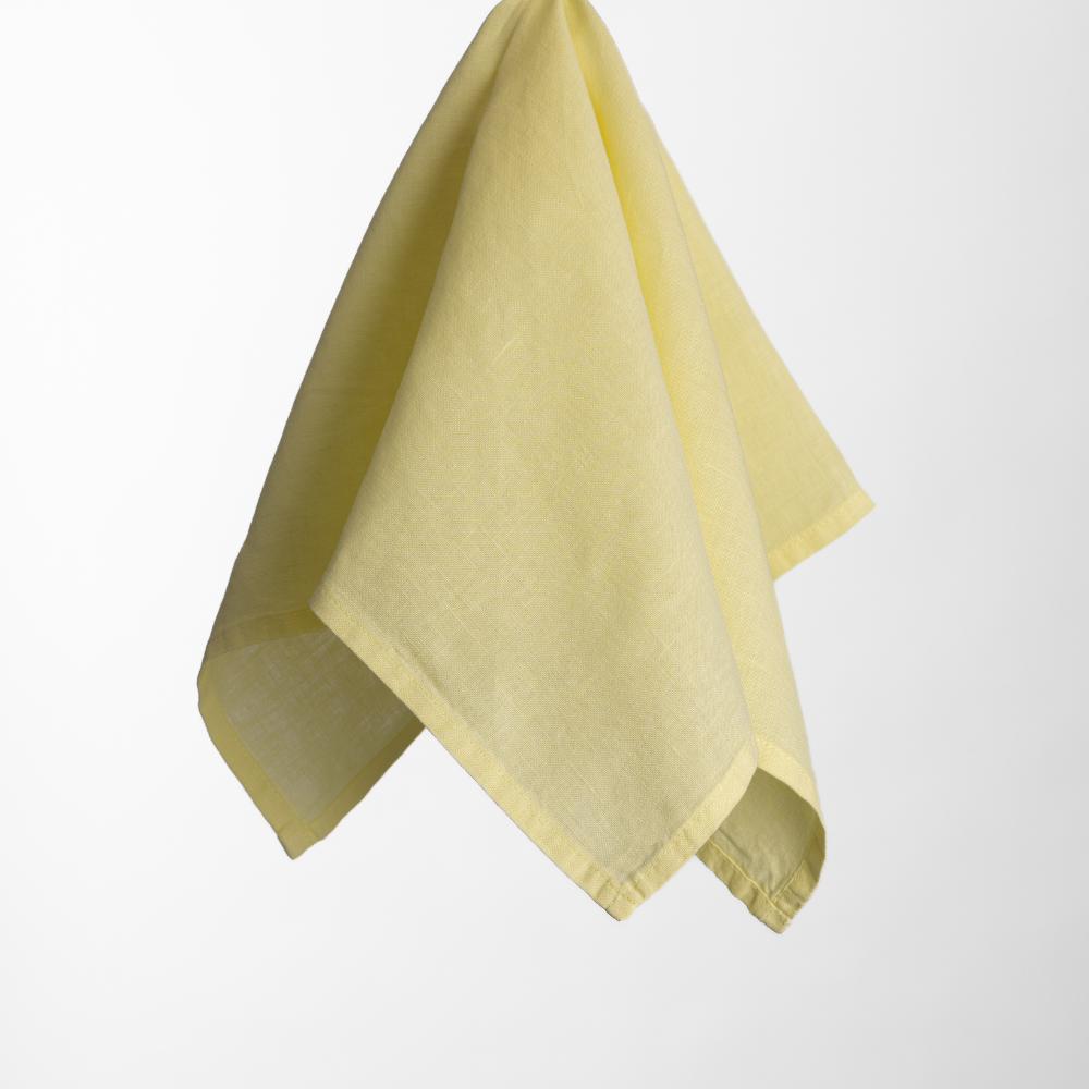 A Madeline Aloe Napkin in yellow is displayed against a plain white background.